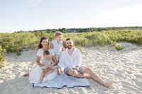 A coastal New England family session with toes in the sand and salty snuggles by the water's edge. North Shore Family Photographer. Deborah Zoe Photography.