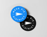 Neue Pie District logo variations displayed on colorful mockups