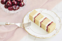 Portion of almond and cherry cake on a vintage plate