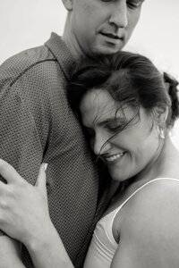 An intimate, close-up moment of a couple embracing, illustrating the natural unfolding of emotion during a Charleston wedding weekend.