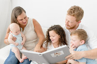 miami family looking at their photo album by Ivanna Vidal Photography
