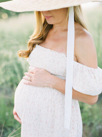 Pregnant mother holding baby bump during Denver maternity photo session