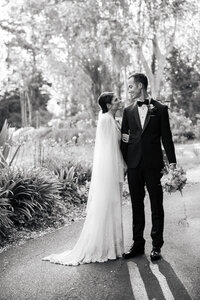Black and white wedding portrait of newlywed couple outdoors