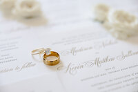 Tennessee wedding photographer captures details of rings on wedding invitation suite