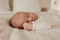 newborn-sleeping-white-knit-fist-cheek-in-home-boulder-photographer-366