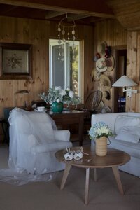 Veil drapes over chair in livingroom of Nantucket cottage. Deborah Zoe Photography.