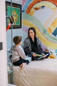 Woman sitting with her son and chatting before bedtime