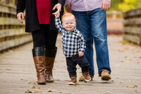 young kid holds mom's hand during mini sessions in Phoenixville