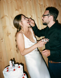 groom feeding bride wedding cake