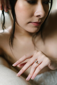 An asian bride wears soft focus makeup and a gentle smile.