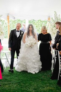 bride walks down isle at belle mer