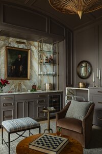 dalay home the hill room with dark wall and bar with marble backsplash