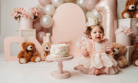 Charleston Cake Smash Photographer- Baby looks into the camera during Cake Smash Photos at Holy City Babies Portrait Studio in Charleston, SC.