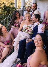 Couple having fun with their bridal party after their wedding at Crag Rat Hut