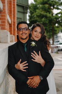 Bride and Groom embracing each other in downtown Covington, Georgia, near Mystic Grill.
