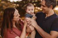 Charleston Baby Milestone Photographer - parents hold their baby during Baby Milestone Portraits in Charleston, SC.