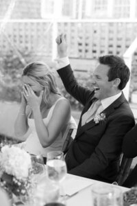 Bride and Groom cheer during wedding reception toasts.
