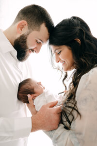 Parents looking down at newborn Miami newborn photographer