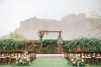 The Paseo Weddings ceremony lawn with arch and mountain view
