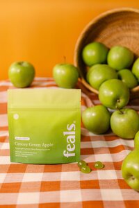 Commercial lifestyle food and beverage photography for Feals CBD gummies, featuring a styled green apple flavor product setup created for CPG website product pages, paid ads, and social media campaigns