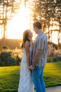 couple holding hands and laughing at golden hour at seascape resort in santa cruz