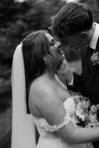 Couple kissing in a black and white photo at a wedding in Boston, Massachusetts.