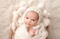Bright, airy portrait of newborn smiling into the camera
