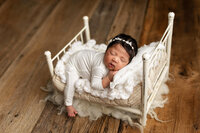 Baby girl on bed. newborn photos near me, mankato area newborn & family photography, southern minnesota photographer