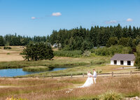 Couple having a private moment in the field on their wedding day at Brightwater weddings and events in Oregon City.