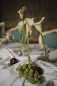 Minimalist wedding table with flowing white linen, delicate glassware, and organic florals