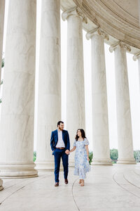 couple holding hands walking  jefferson memorial columns