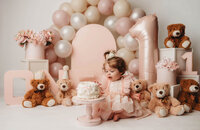 Charleston Cake Smash Photographer- Baby looks into the camera during Cake Smash Photos at Holy City Babies Portrait Studio in Charleston, SC.