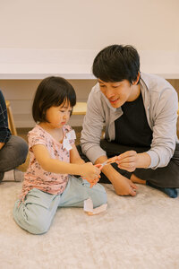 Father and daughter doing a craft together with scissors