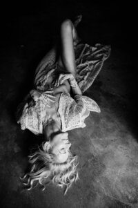 Boudoir experience studio model lying on floor