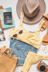 Styled product photography flat lay of apparel and accessories photographed to create a warm, seasonal lifestyle scene