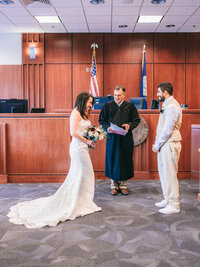Funny moment during the ceremony at SF City Hall. Photo by 4Karma Studio. Wedding photographer in San Francisco