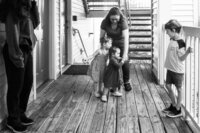Two toddlers fight to be close to their grandmother