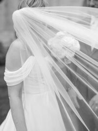 Black and white close-up of bride with flowing veil captured in Detroit wedding photography