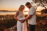 Maternity Photos in Charleston, SC -- Expectant mother poses for Maternity Portraits during Sunset on the Marsh Charleston, SC.