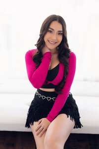 A Pewaukee High School student sits on a white bench in our Waukesha photo studio.