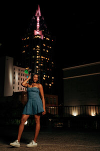 Senior portrait in downtown Mobile, Alabama — standing on a parking garage at night with the
RSA Tower lit in the background.