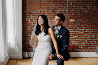 bride and groom  in brick venue