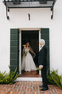 bride looking out a doorway at her guests in jekyll island, georgia 
