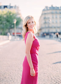 Cari looks over her shoulder in pink dress in Paris