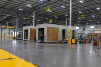 The inside of a warehouse with individual sheds in it