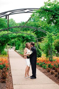Bright flowers surrounding couple who are whispering to on another during their Cheekwood photoshoot