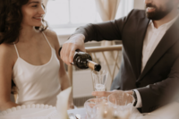 Couple pouring champagne for micro-wedding at Maison Charlottesville. Photography by Amy Mitchell.