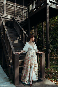 Newly married couple standing outside Airbnb cabin in North Georgia mountains for cinematic photos. Photos by Crimson Conure Photography based in Kennesaw, Georgia and Denver, Colorado