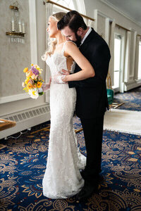 groom kissing bride's shoulder taken by wedding photographer georgia