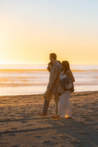 sunset beach couple walking on sand barefoot in santa cruz